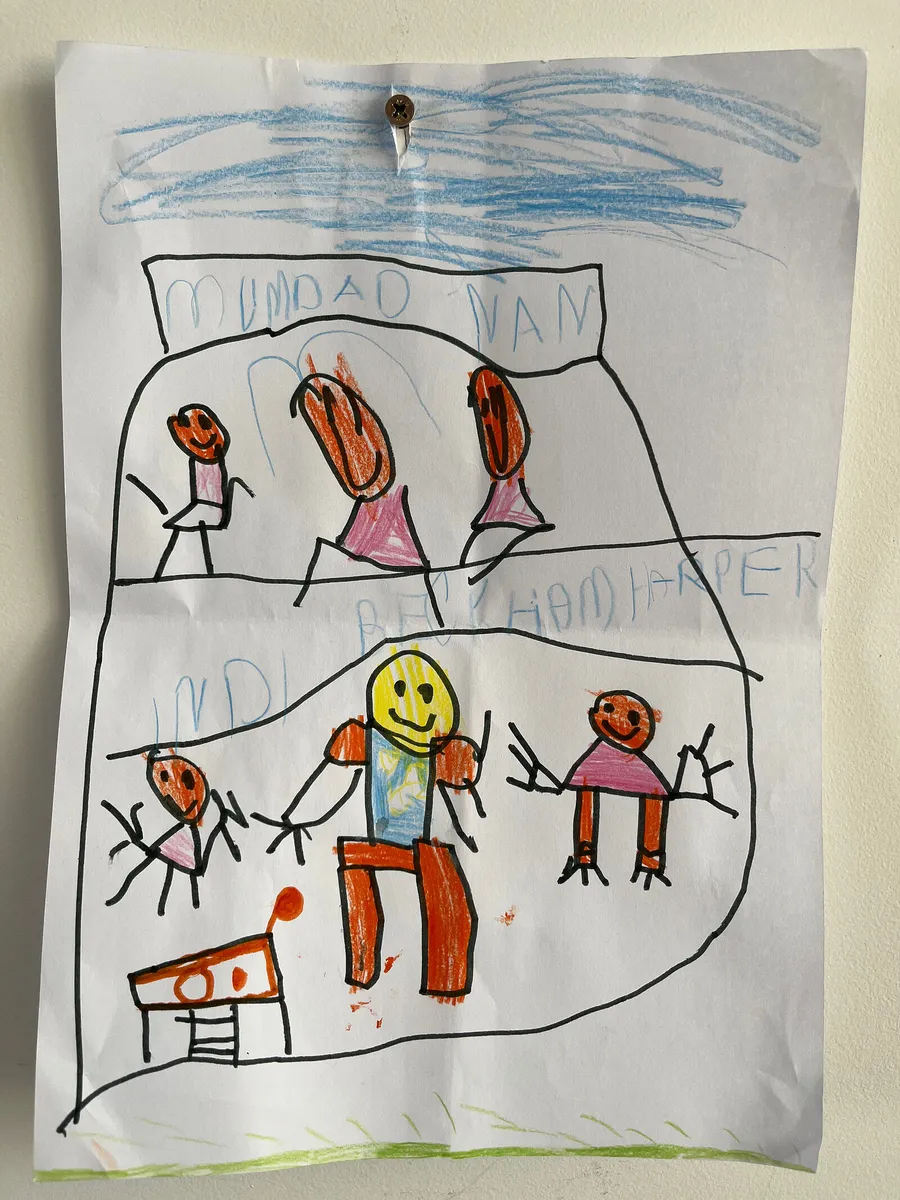 Beckham’s crayon drawing of the family, with Indi on her trampoline in the corner