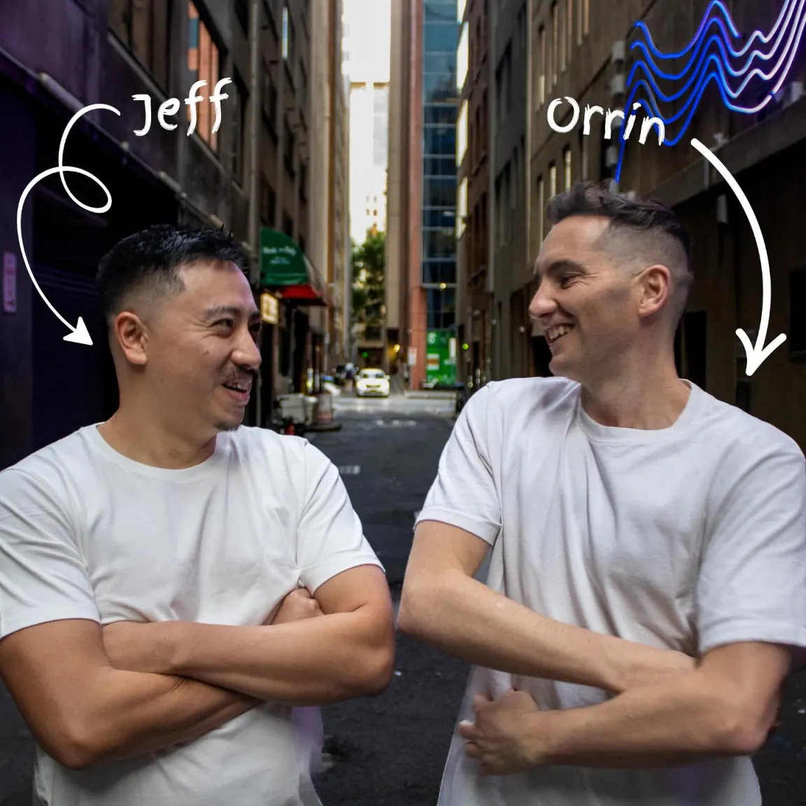 indi co-founders Jeff and Orrin grinning at each other in a Sydney laneway